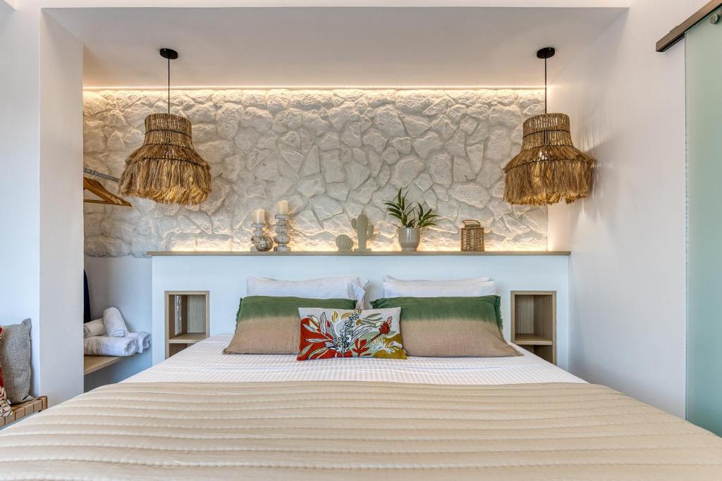 Modern bedroom with stone feature wall and woven pendant lighting.