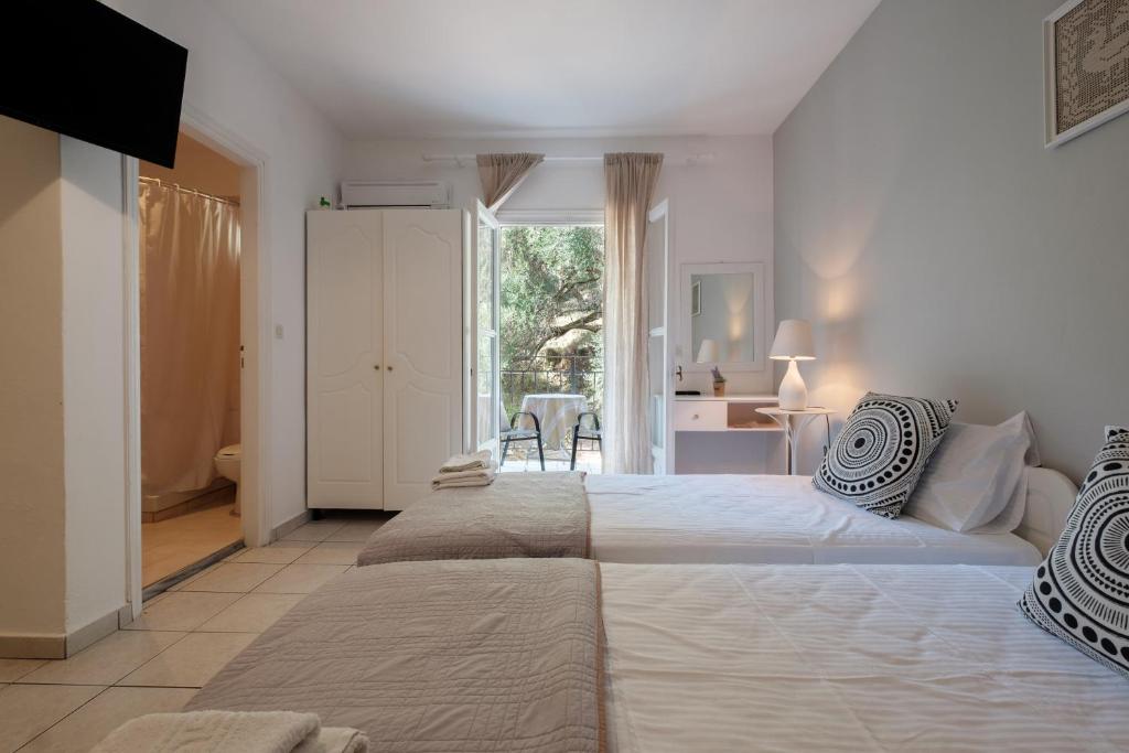 Studio interior with twin beds and a balcony door