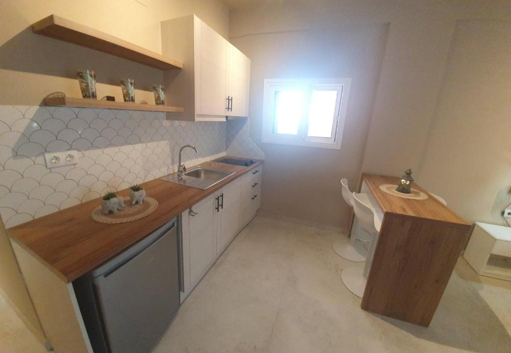 Guest kitchenette with worktop and storage.