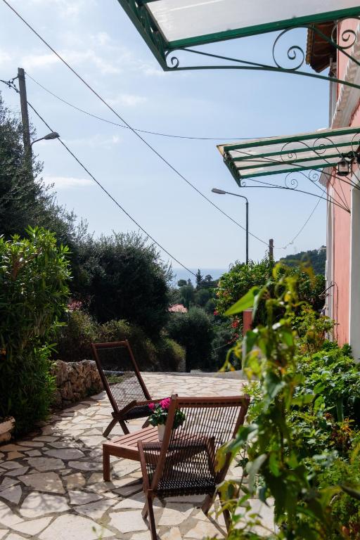 Outdoor terrace/path area with vegetation.