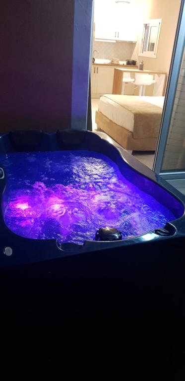 Indoor hot tub with colored lighting.